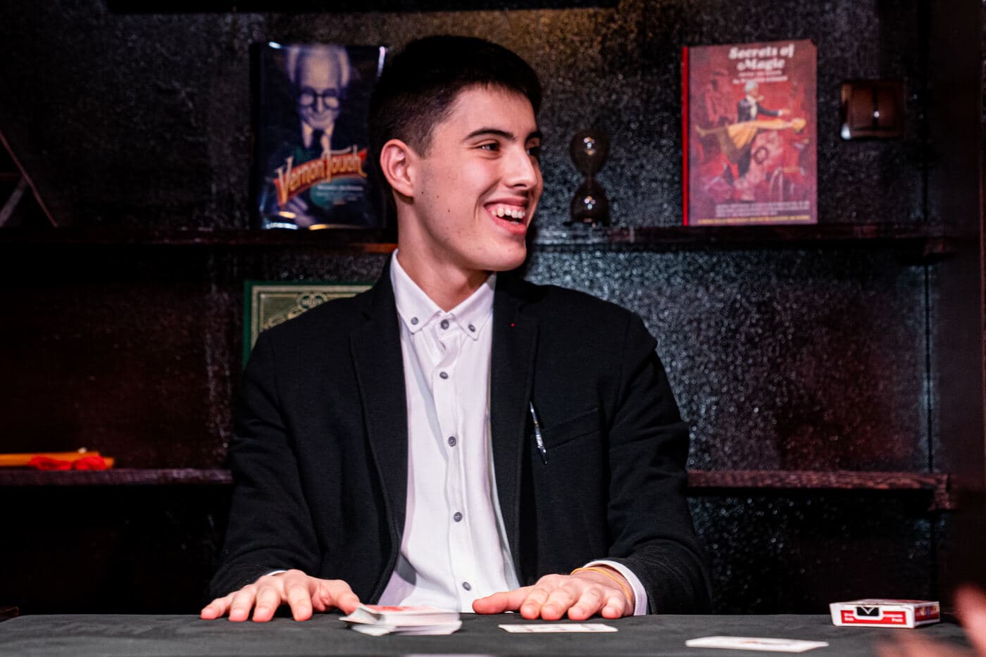 Rado Sheytanoff laughing with guests at the card table during a live show